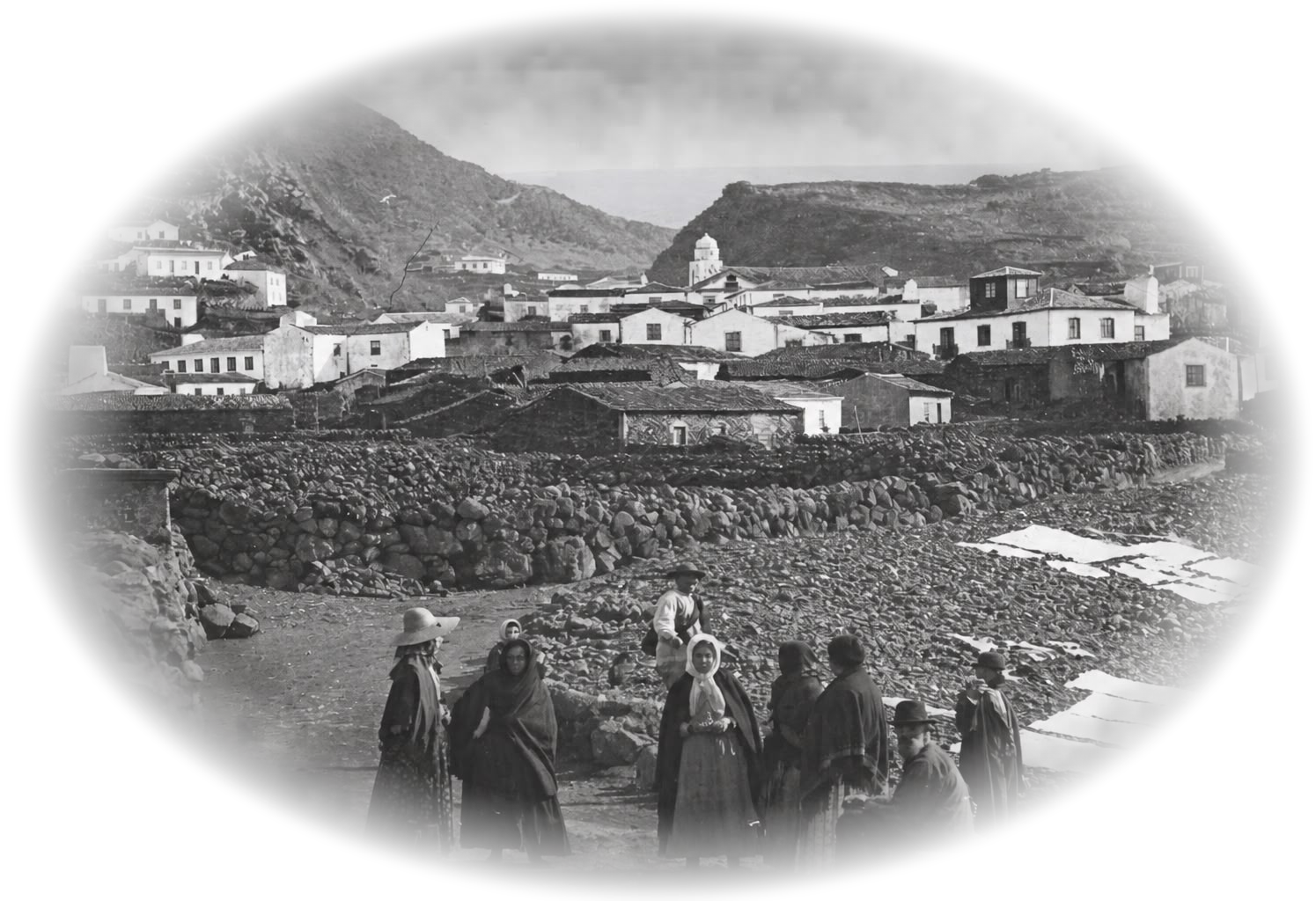 Historical photograph of an Azorean whaling village, with women in the foreground